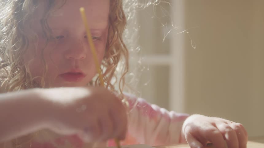 The child is painting at home