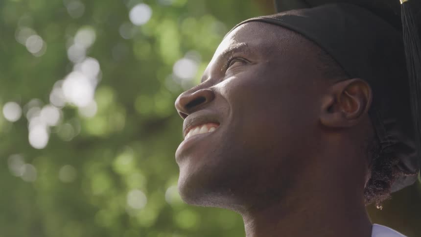 Smiling man outdoors with graduation chapel