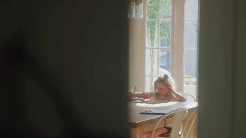 Little girl sitting at a table painting
