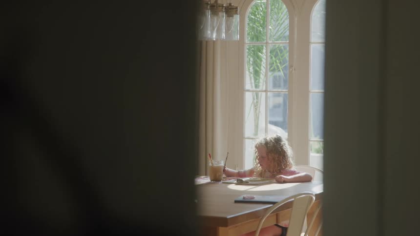 The girl is painting across the room
