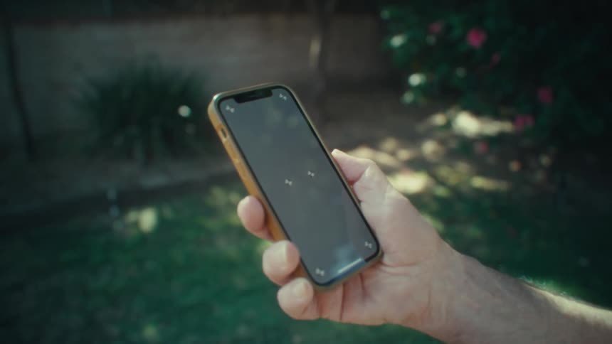 Closeup shot of a persons hand holding a smartphone vertically