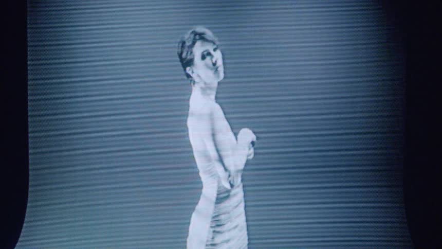 Screen showing a woman in a white dress