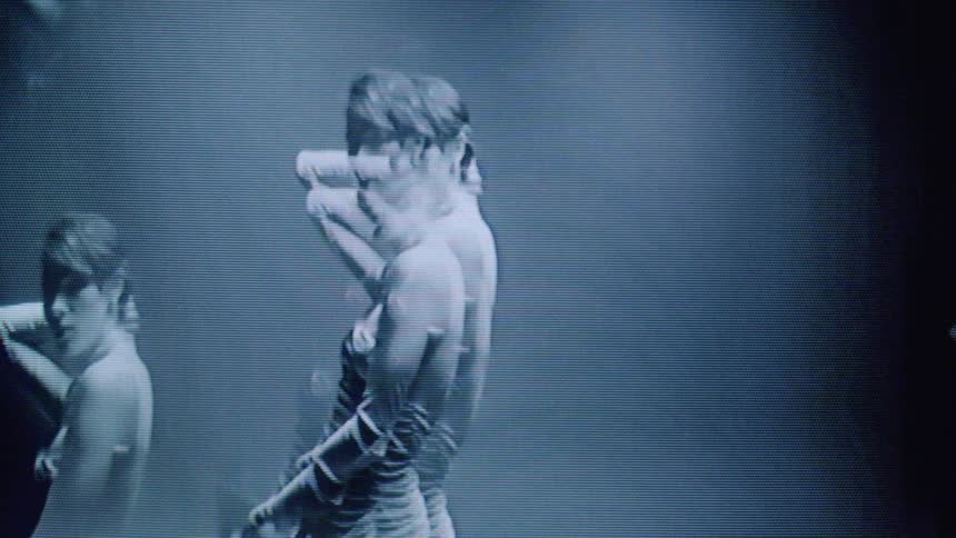 A mirrored model is posing in a dress
