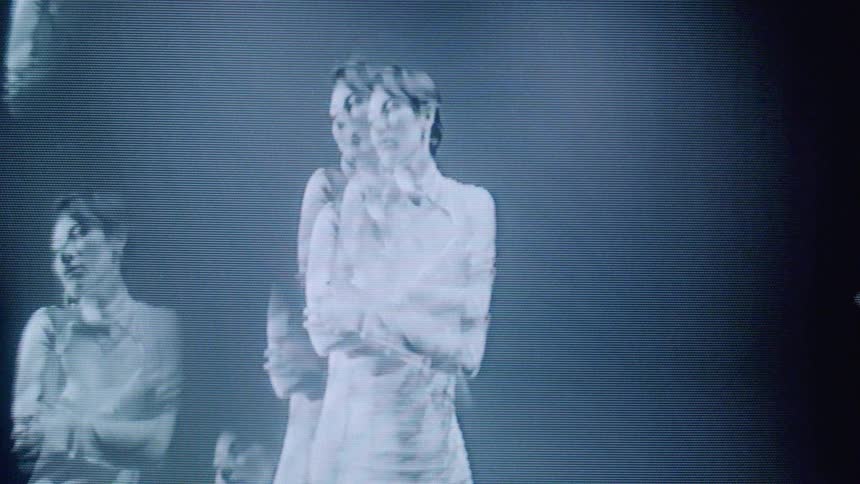 Multiple reflected images of a dancing woman overlap