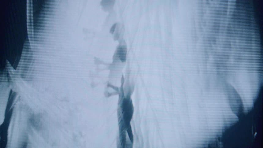 The video features an abstract somewhat eerie visual of a persons silhouette surrounded by what appears to be flowing water or a similar transparent fluid medium creating a ghostly or ethereal effect the figure is mostly static but occasionally exhib