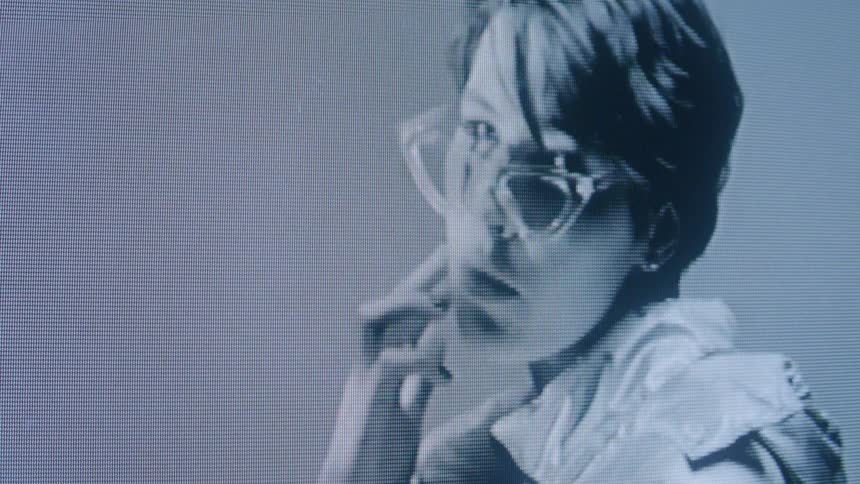 The woman is modeling a pair of glasses