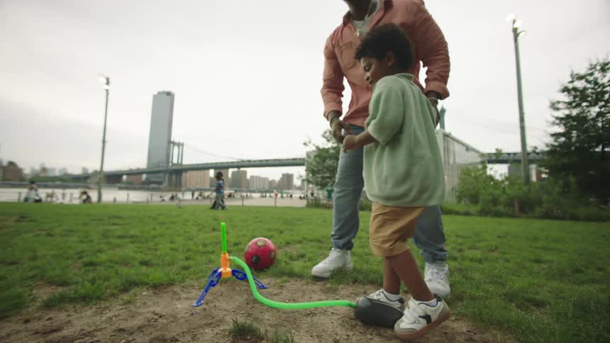 Father in an outdoor park playing with his son