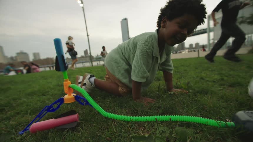 The child watches as the toy rocket is fired