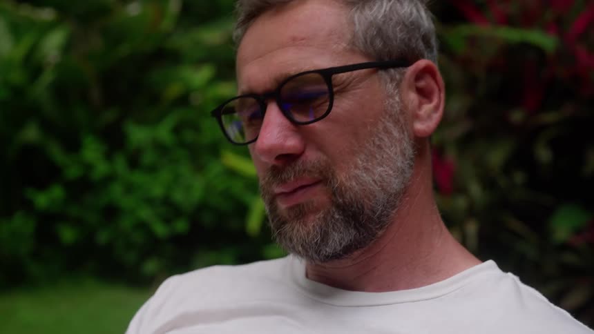 Portrait of a man with glasses in the backyard