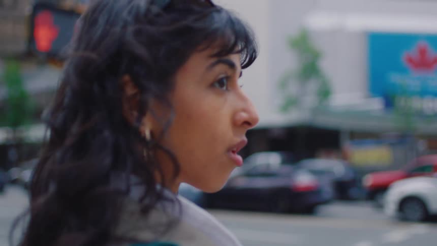 A woman is waiting to cross the street