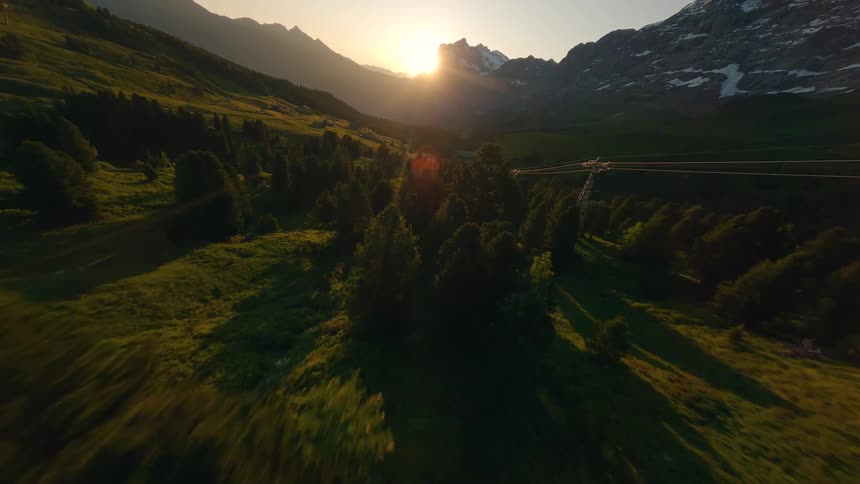 The sun is rising on the mountains ahead