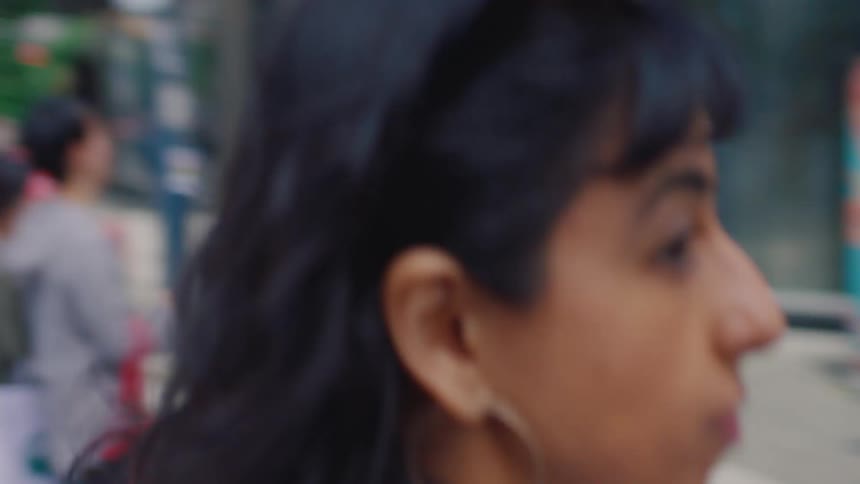 A woman looks both ways as crossing the road