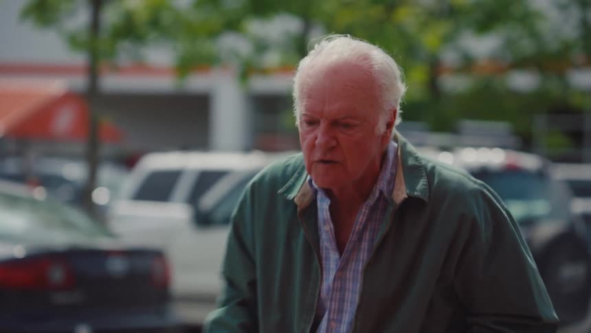 Elderly man in a parking lot extremely angry