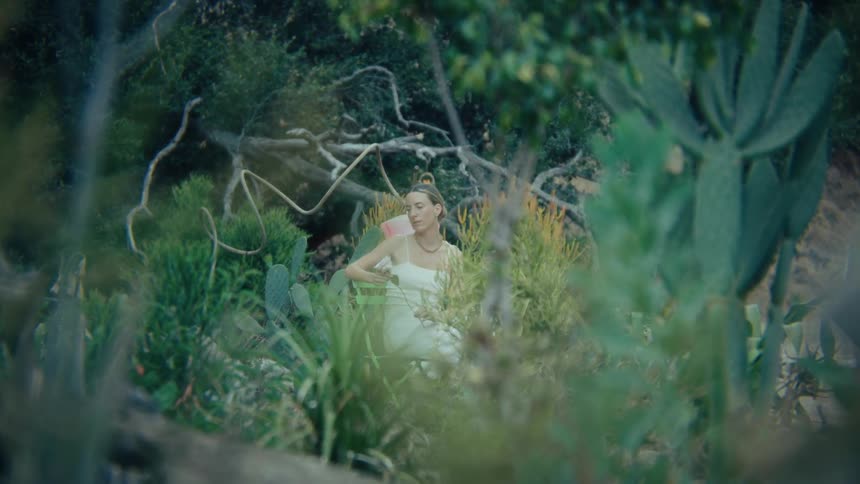 A bride taking a photoshoot in the woods at midday