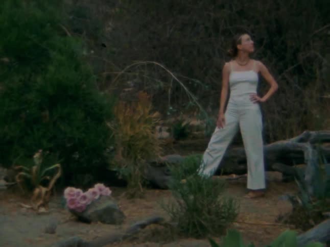 The woman looks around by the mountain