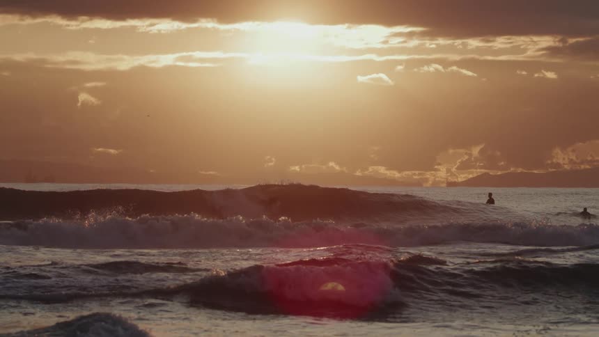 Two surfers are out in the water