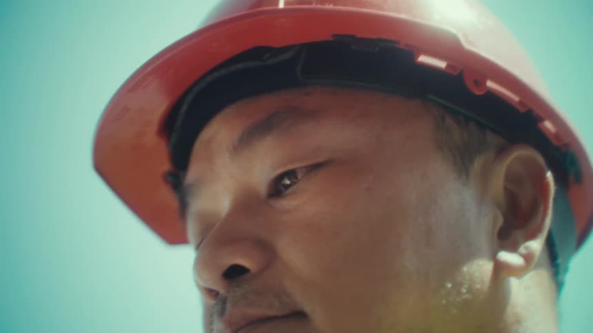 Man in red protective helmet holding an ipad