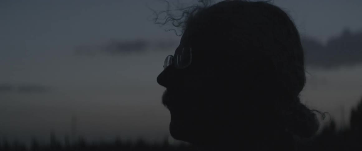 A man looks over the horizon at dawn