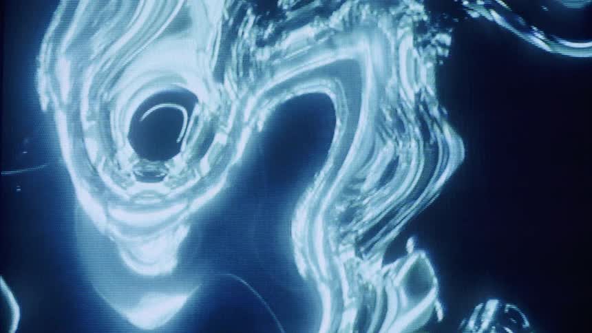 Abstract closeup of swirling liquid like metallic patterns on a dark background