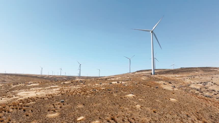 Wind turbines in action against a blue sky