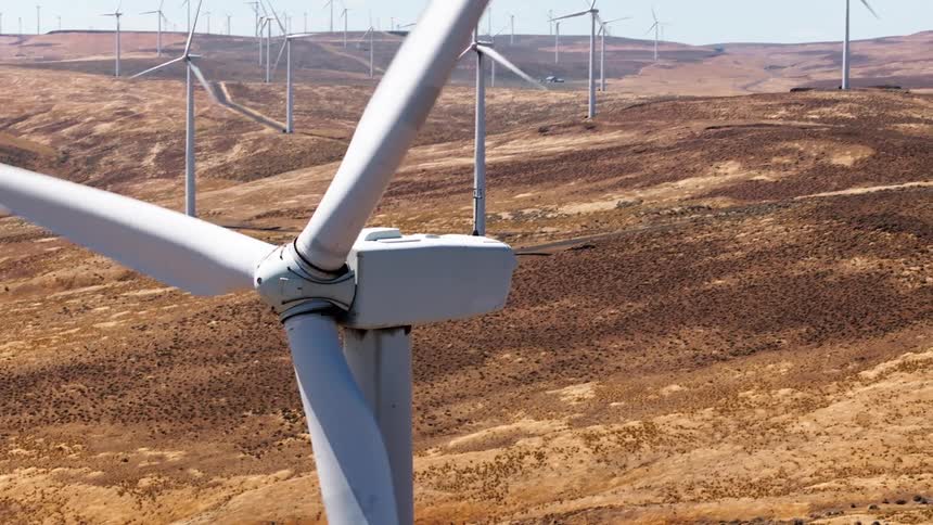 The long blades of the windmills are spinning
