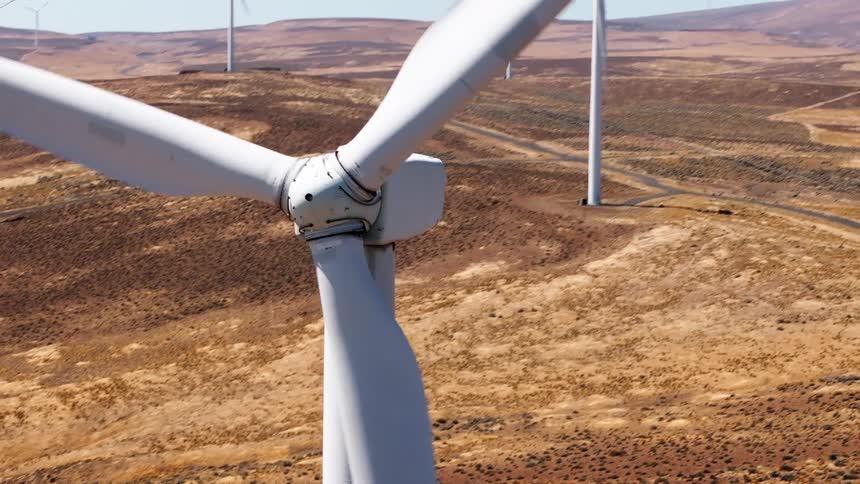 The sky is clear above the wind farm