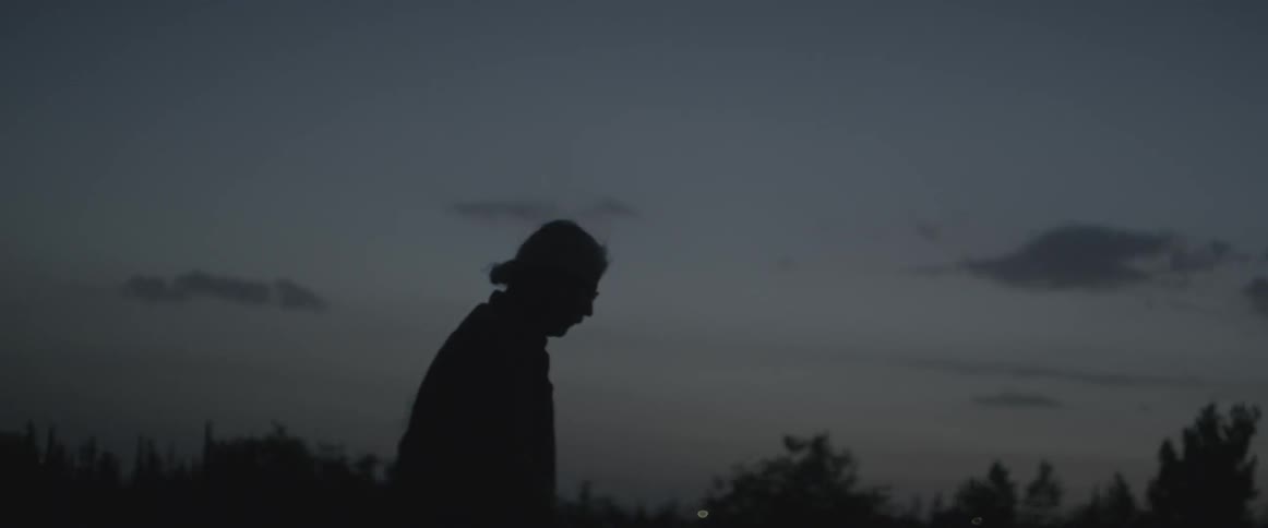 A man is hiking at dawn