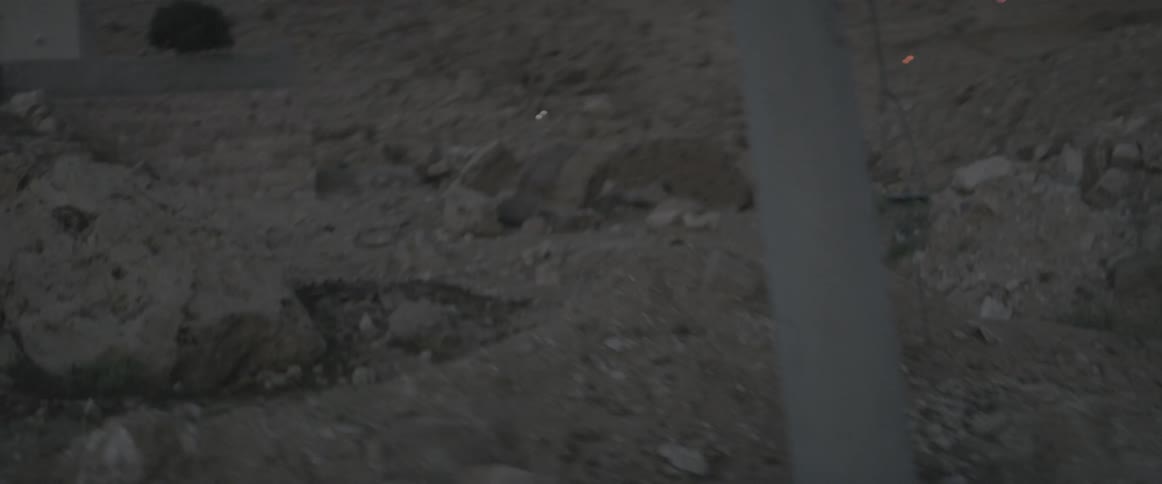 A man is running down the rocky field