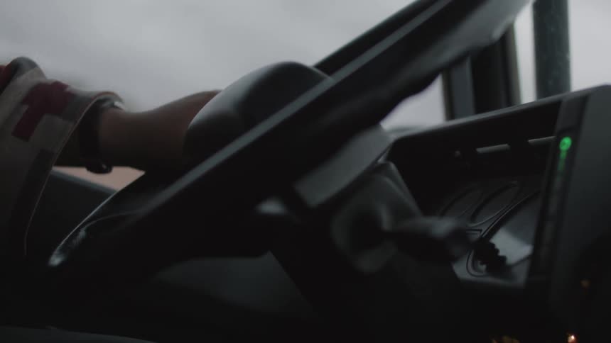 Hand on a vehicle steering wheel