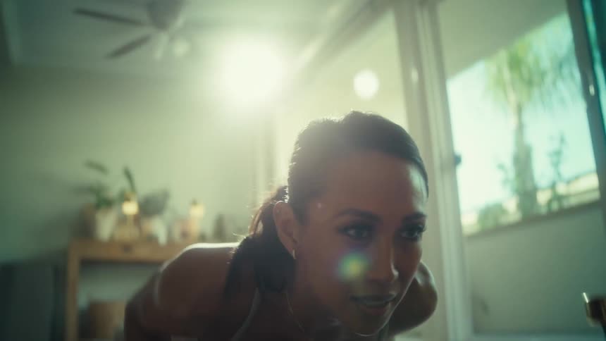 A woman is doing push ups at home