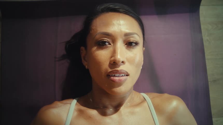 Woman lying down with a smile and a sweaty body