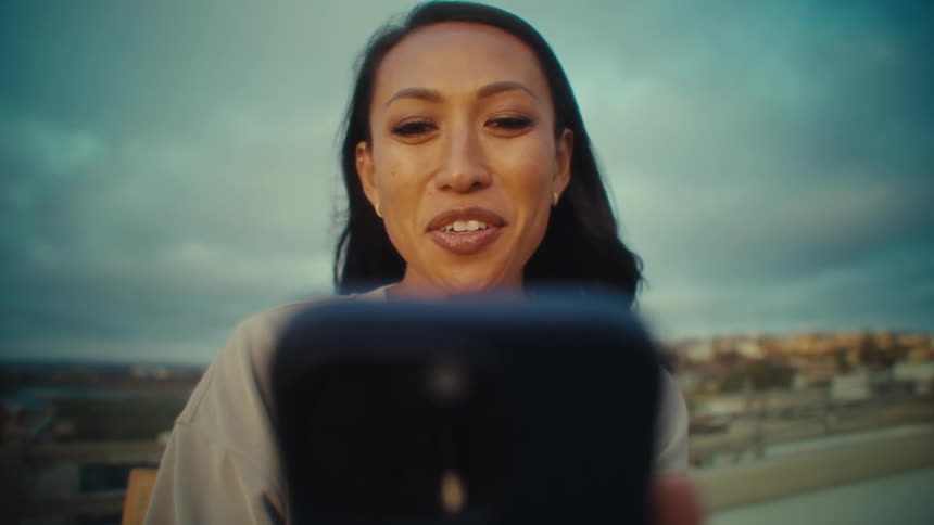 Woman holding her phone in front of her to participate in a video call