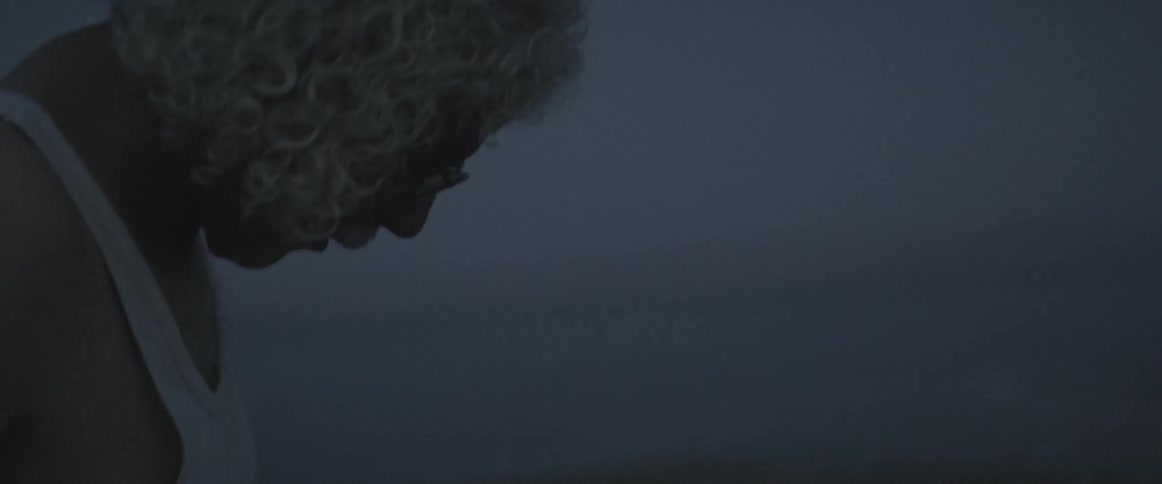 A man stands outside on a foggy day