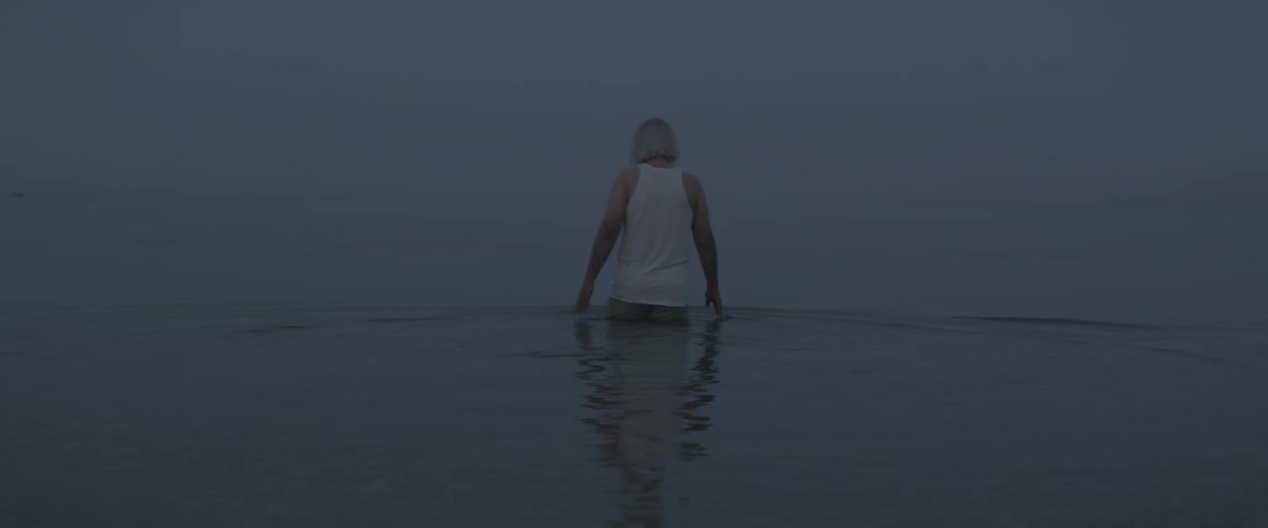 A man is wading in the water