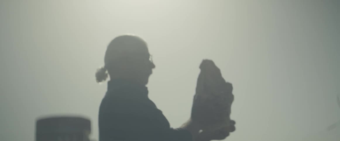 A man admires a sculpture outdoors