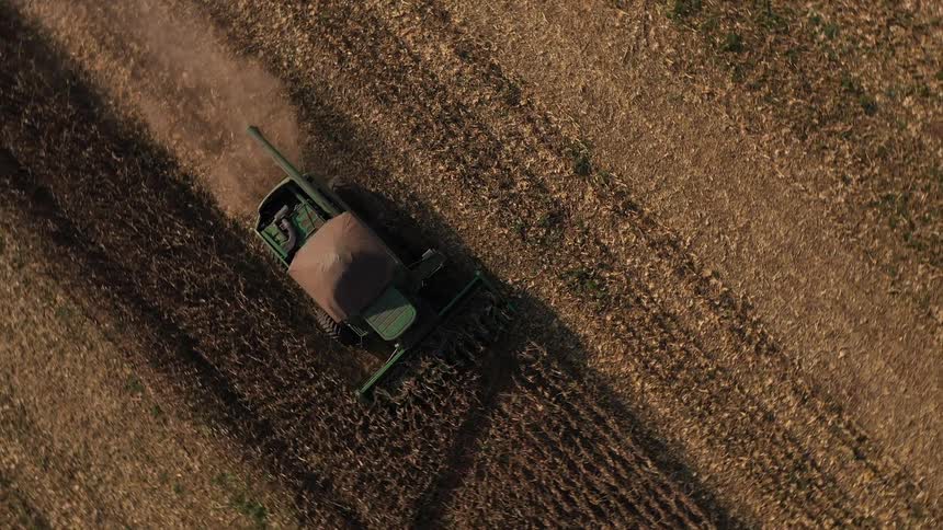 Tractor tilling the soil in an empty field