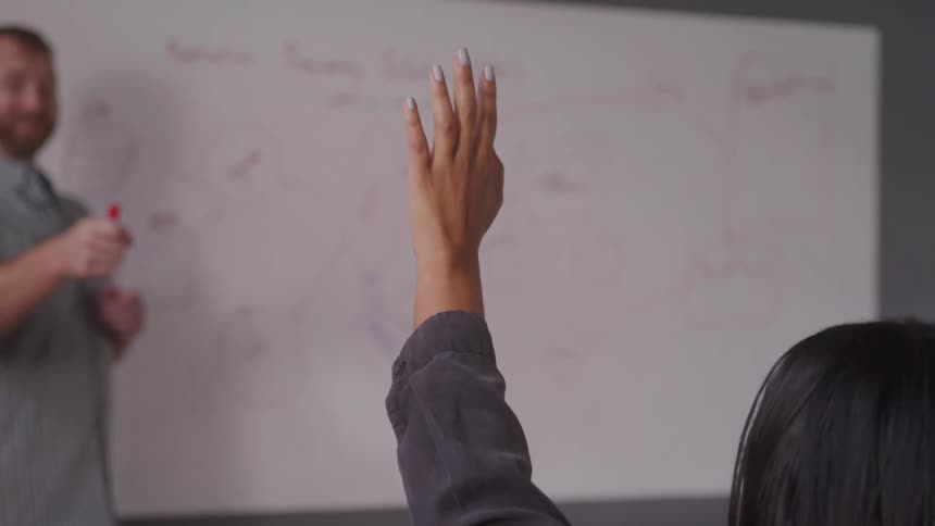 A student raises their hand and is picked by the teacher