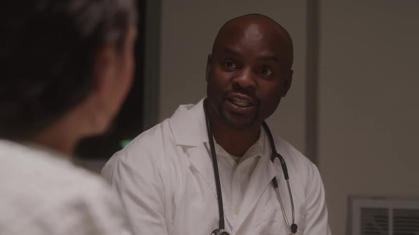 A doctor discusses medical results with a patient in a hospital bed