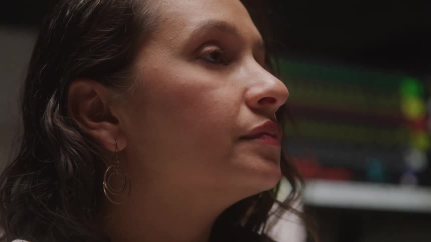 A woman looks thoughtful and slightly concerned in a clinical setting