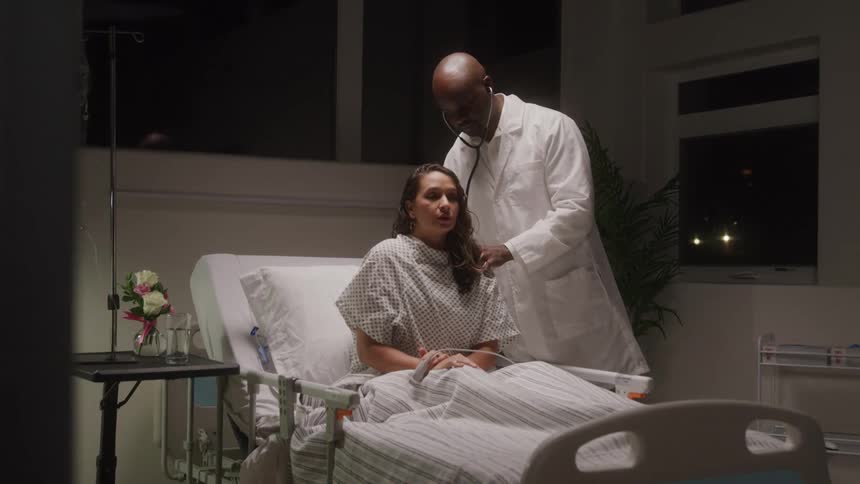 Doctor examining a patients breathing in a hospital room