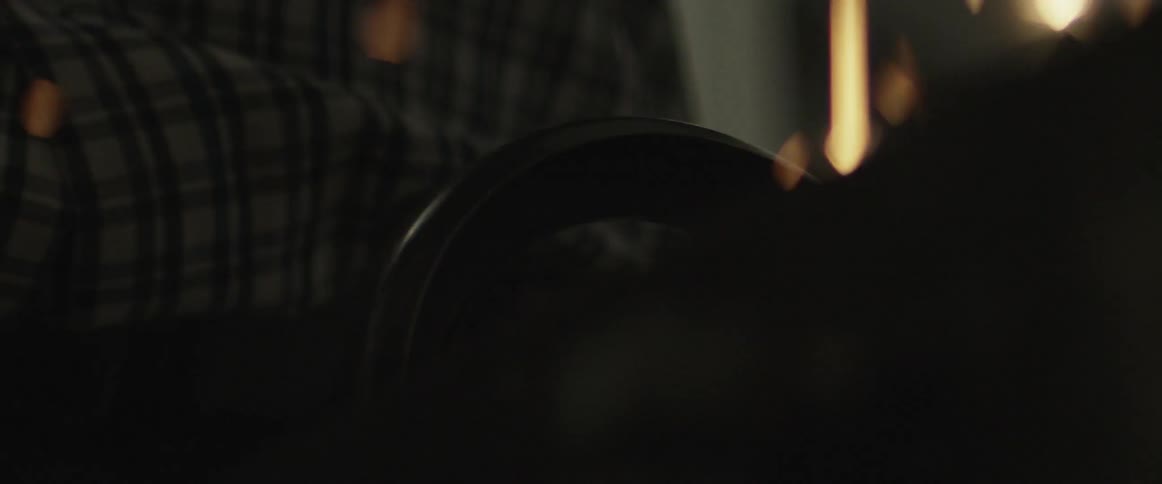 Sparks fly near a plaid shirt