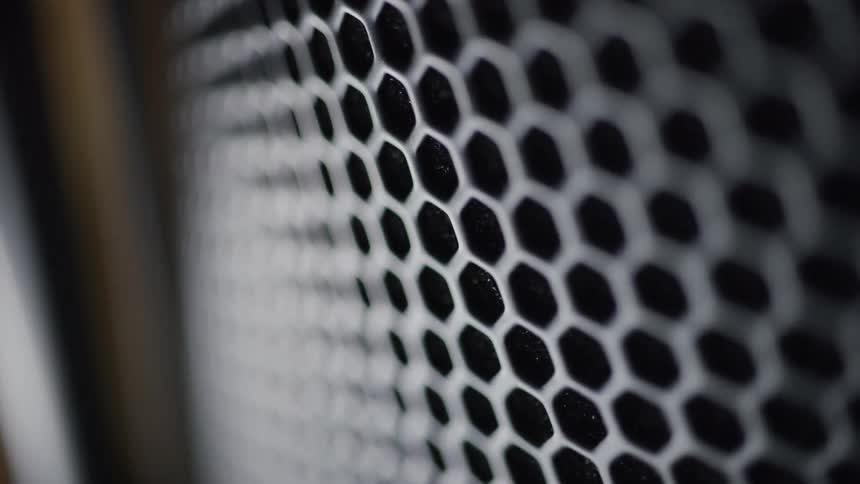 A closeup of a black honeycombpatterned surface with white edges