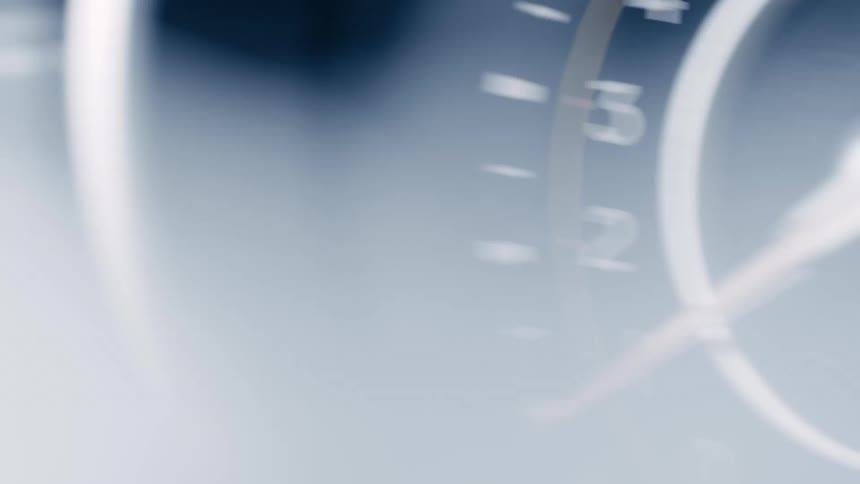 Closeup of a shaking odometer with moving hands
