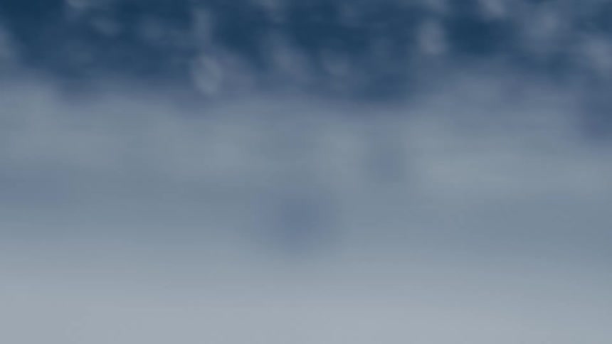 A blurred blue and white scene suggests movement or focus on water or mist