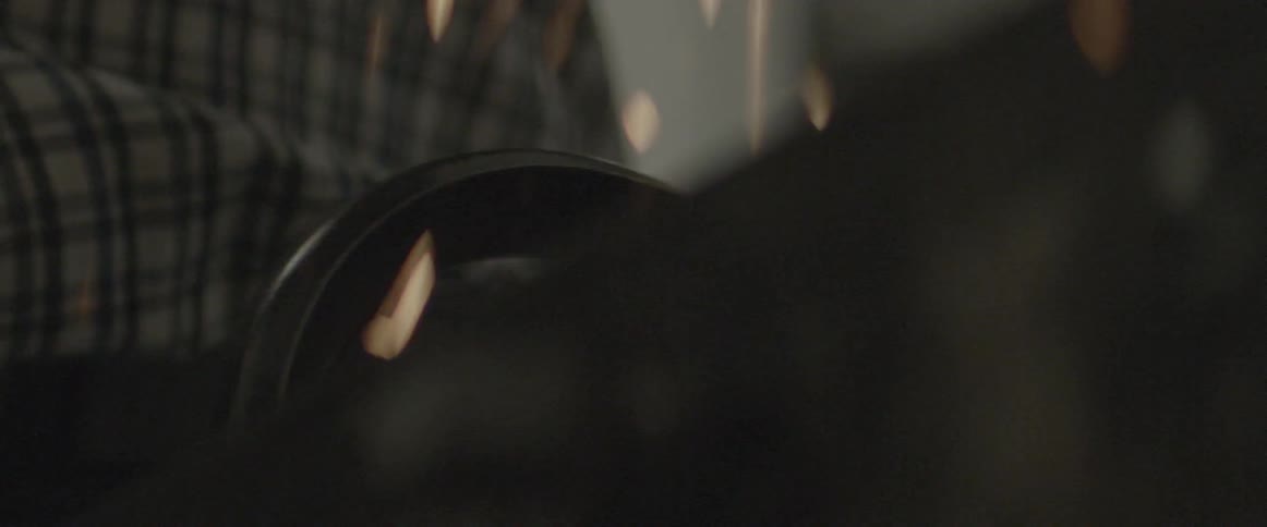Sparks fly as a man uses a grinder