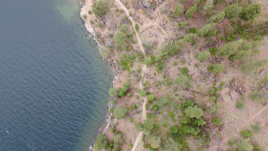 The water is hitting the shore of the island