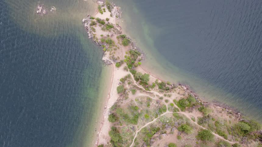 Birds eye view remote island surrounded by blue ocean waters