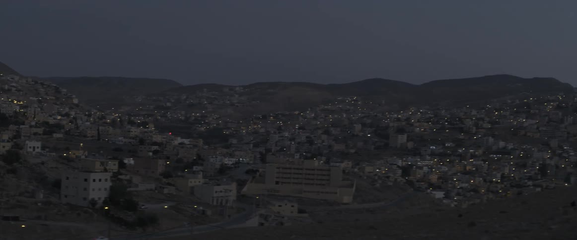 A city in a valley at dusk