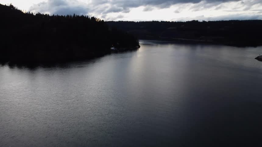 Landscape of a river surrounded by silhouettes of trees