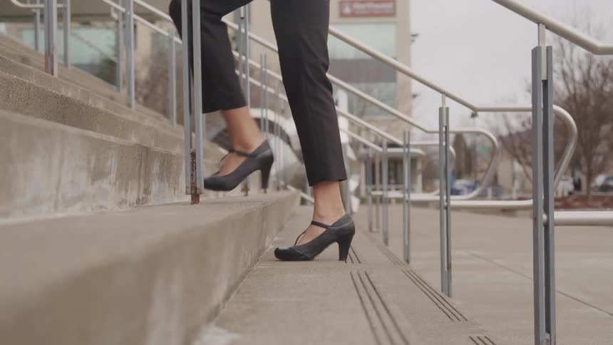 Woman in high heels climbing stairs
